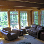 Cherry Dip Cottage Living Room area with large glass windows.